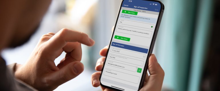 A person holds a smartphone, using their finger to interact with a form on the screen for signing off an inspection—an example of how Recommended Safety Software streamlines fields for date, name, and email.